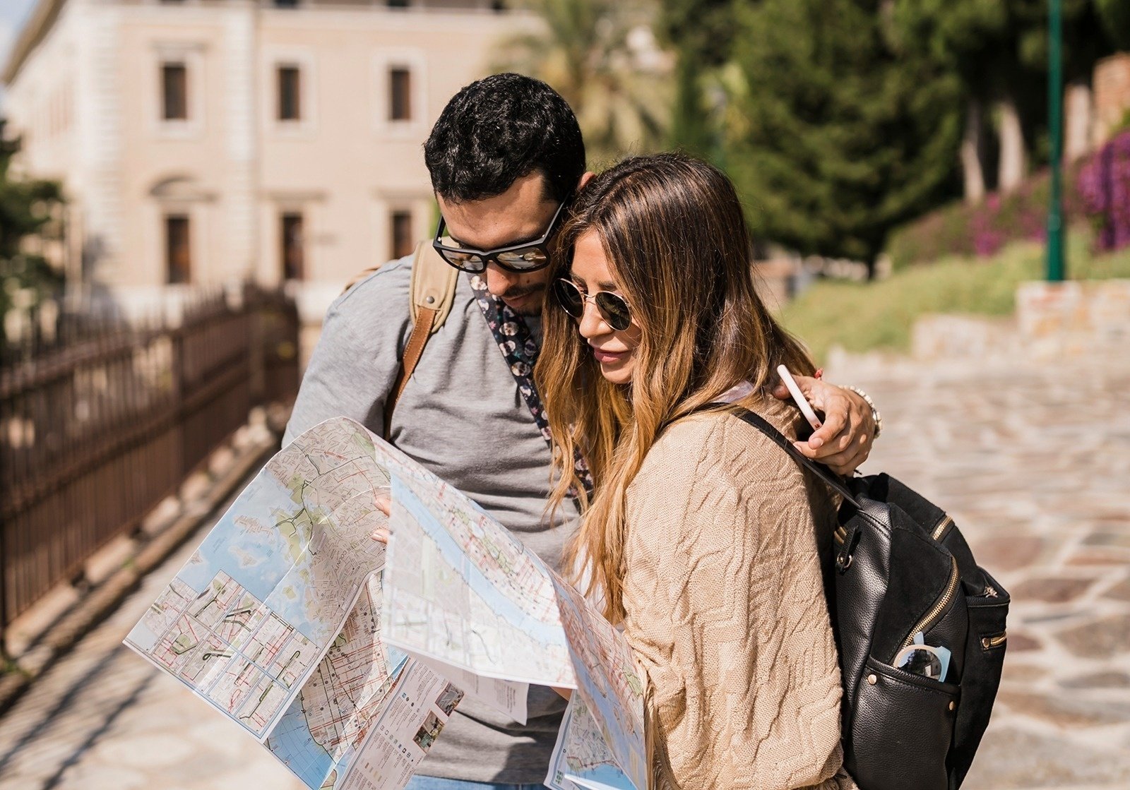 a man and a woman are looking at a map of a city