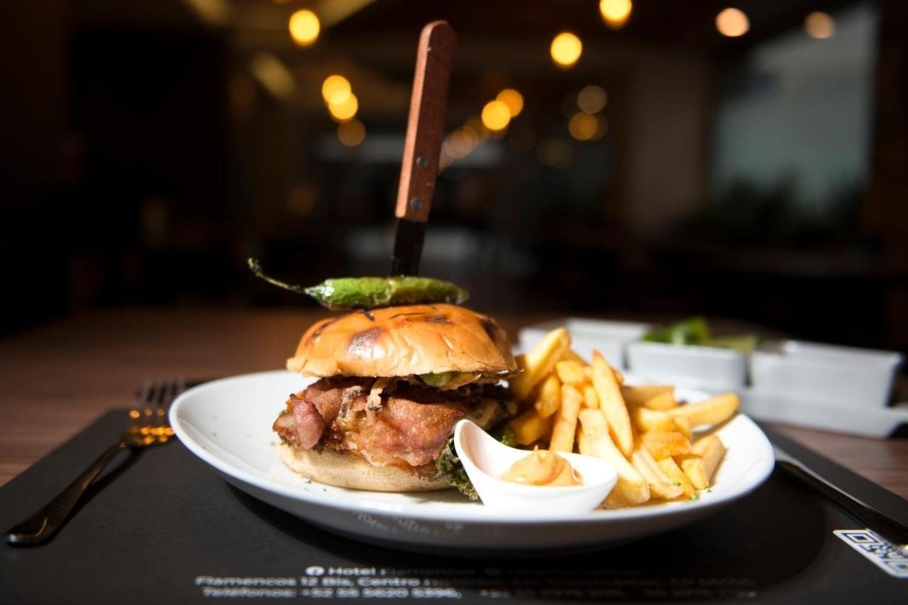 a hamburger and french fries on a white plate