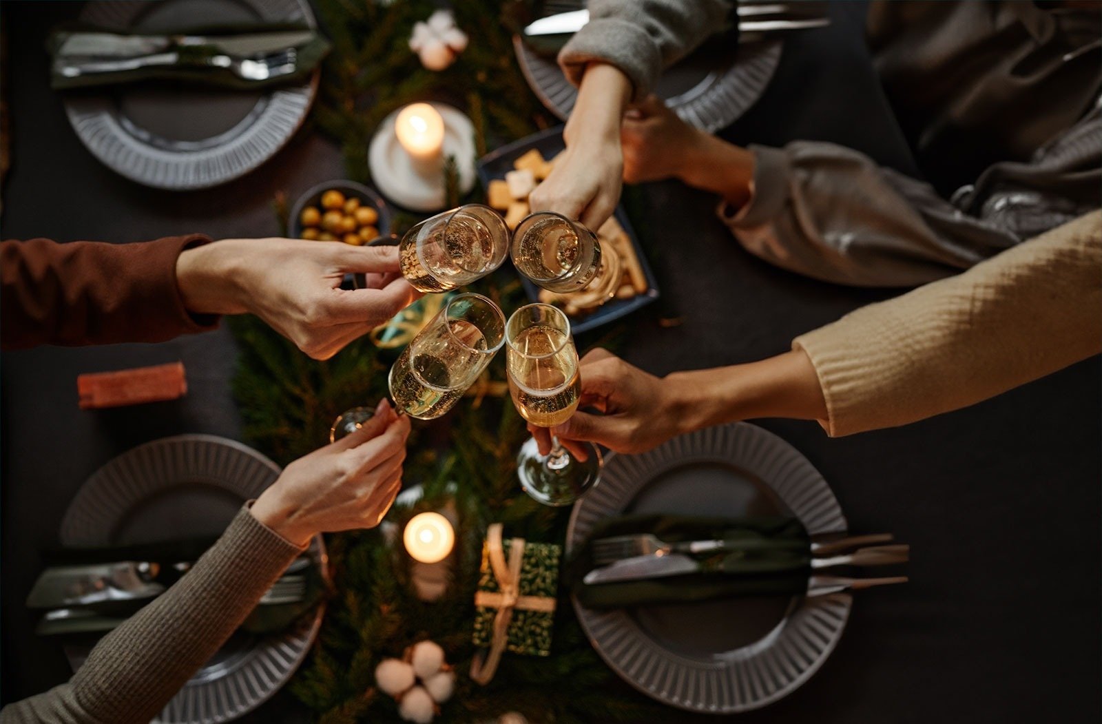 a table set for a dinner with plates glasses and candles