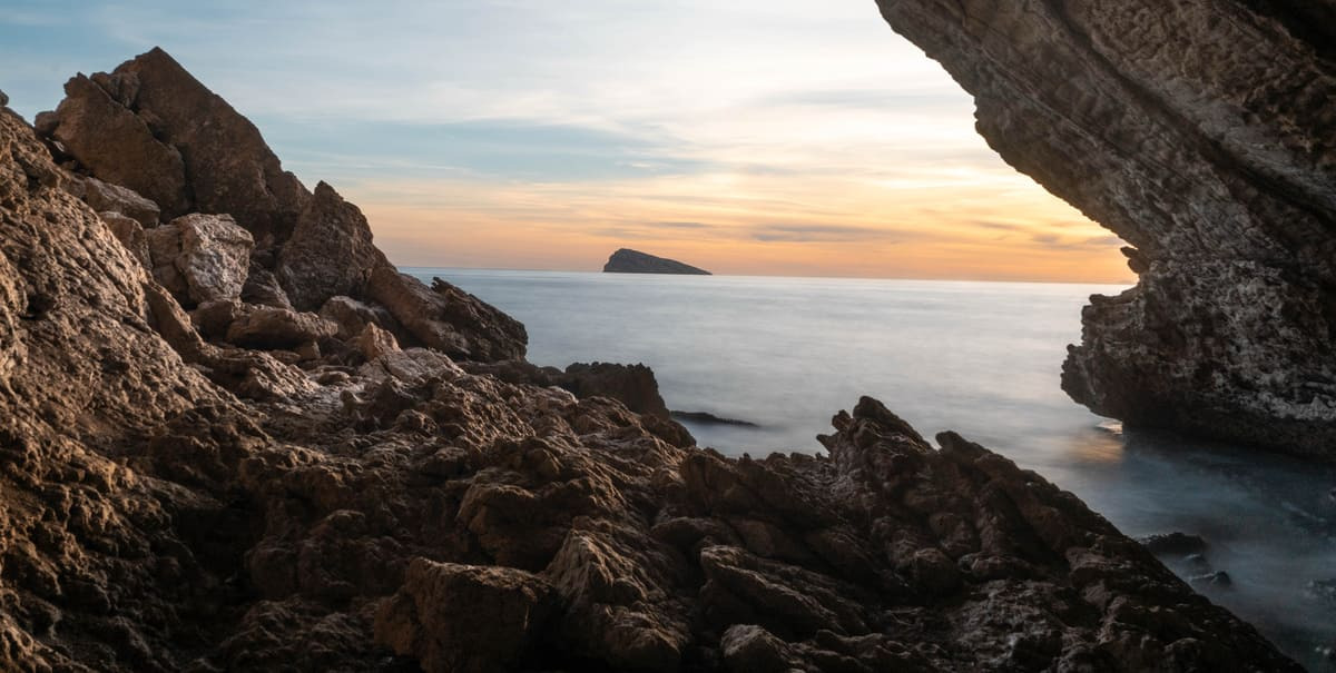 View from a cave of a sunset over the sea, near the Flash Hotel