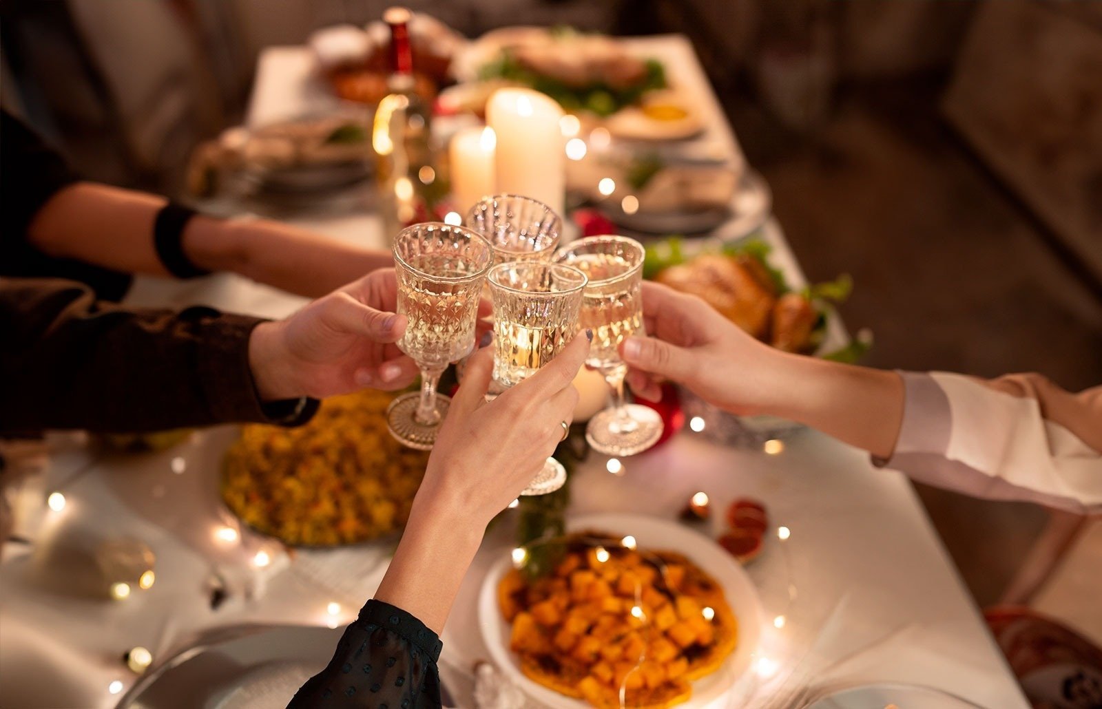 a group of people toasting with wine glasses