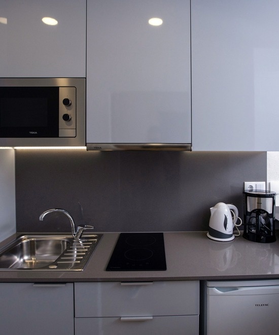 a hotel room with two beds and two pictures on the wall