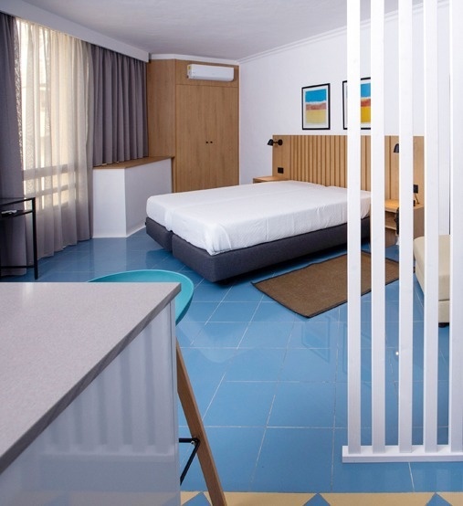 a deck with tables and chairs under a white canopy