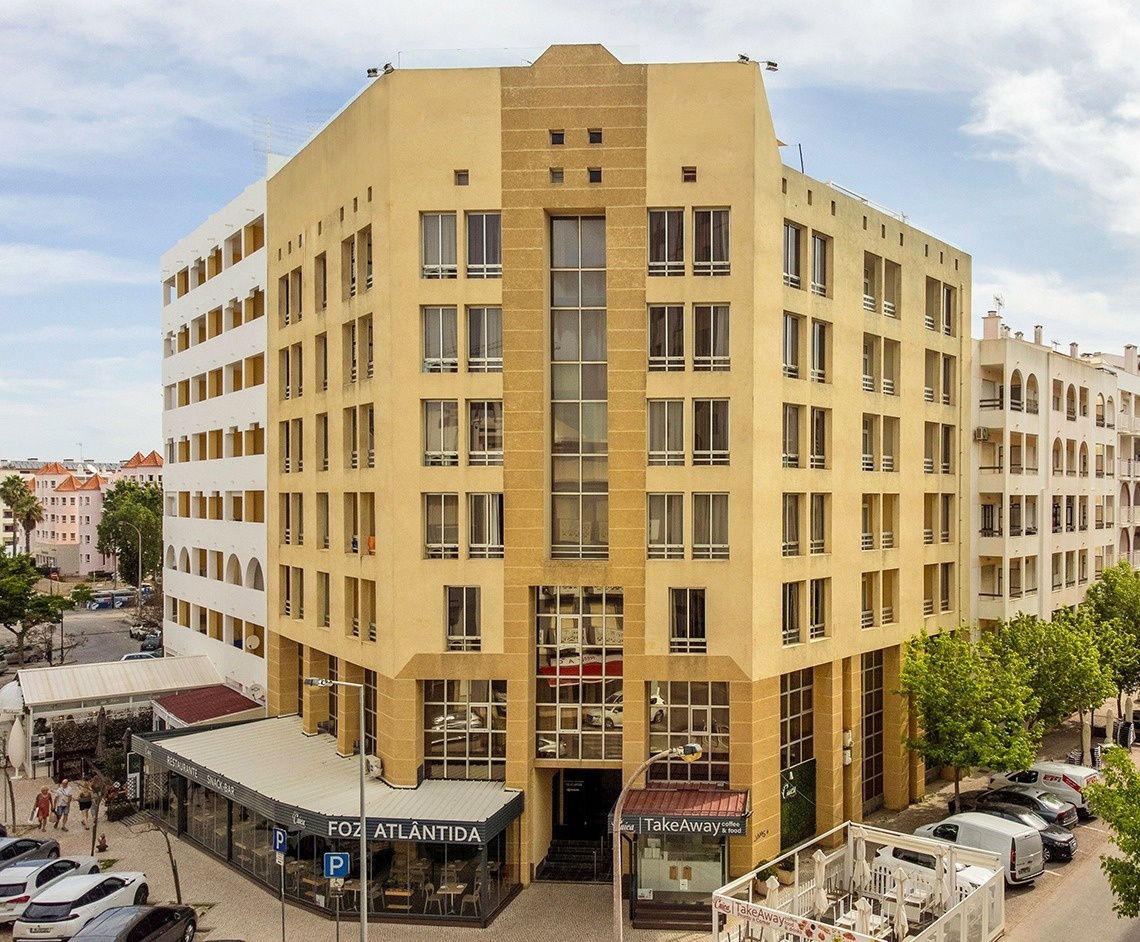 a large building with a restaurant called foz atlantida in front of it