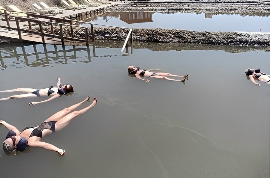 quatro mulheres em maiôs estão flutuando na água