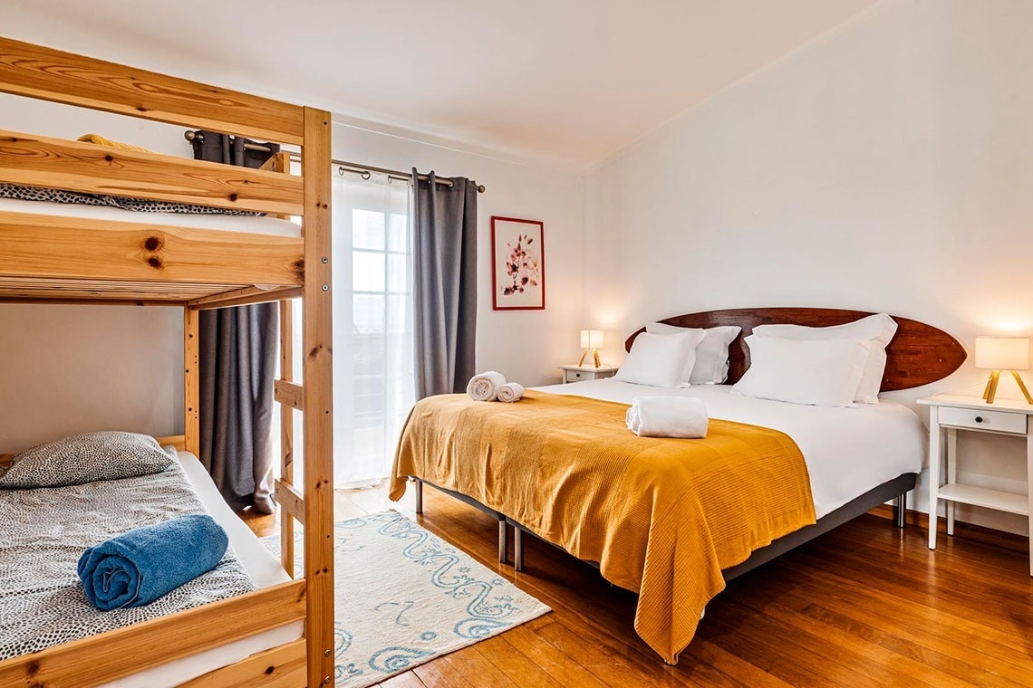 um quarto de hotel com cama , cadeira , televisão e janela .