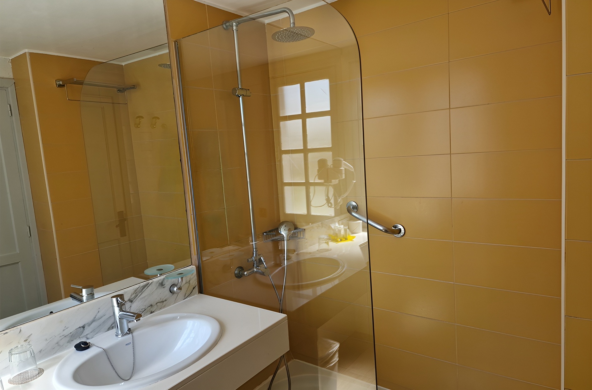 a bathroom with a sink and a walk in shower