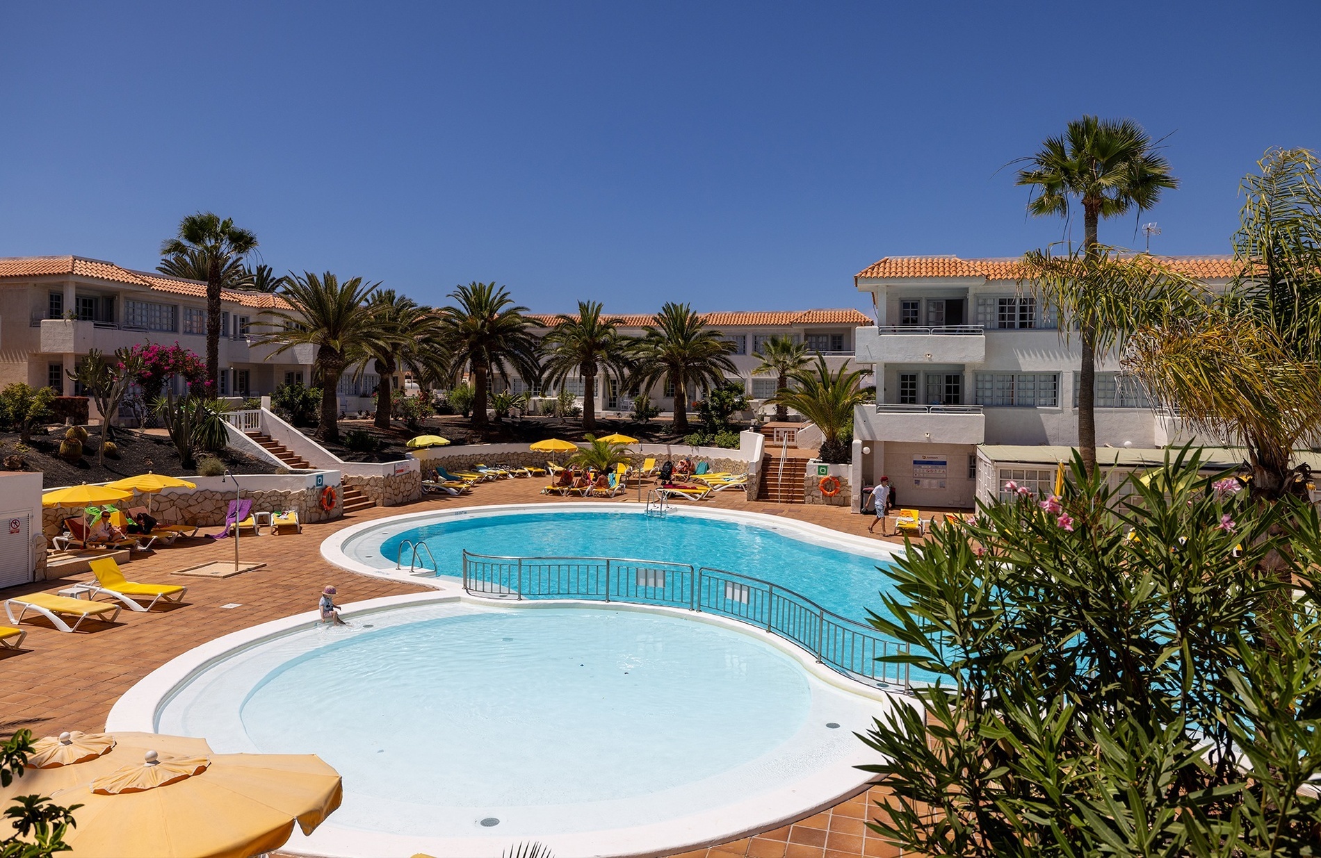 a large body of water with a sandy beach in the background
