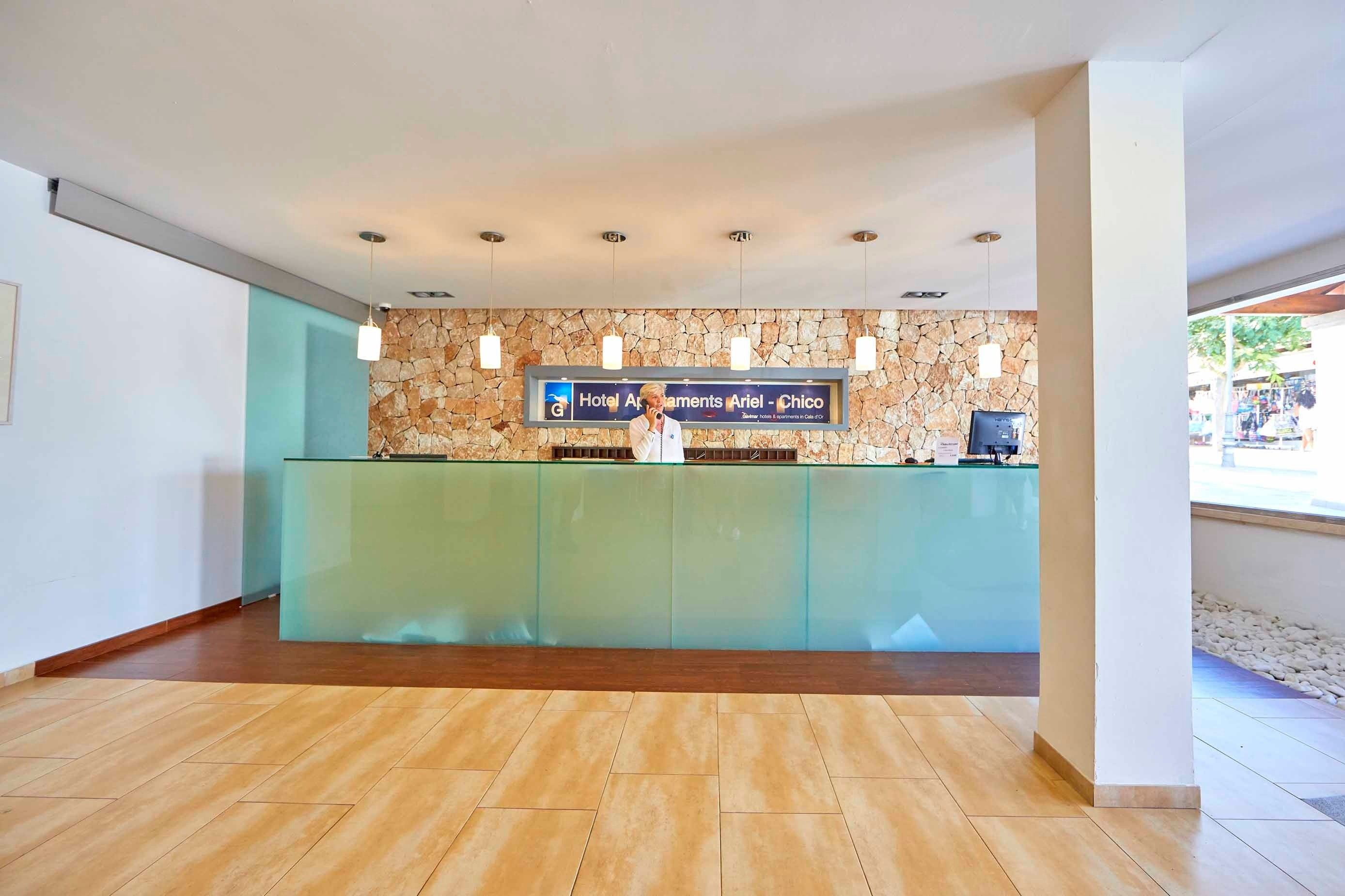 a reception desk with a sign above it that says hotel