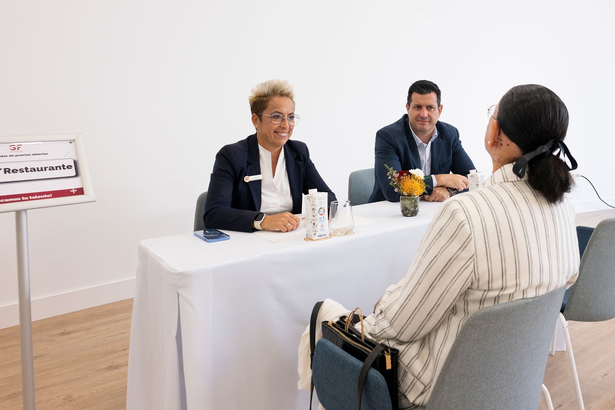 a man stands at a reception desk in a lobby