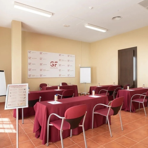 a room with tables and chairs and a sign that says gf