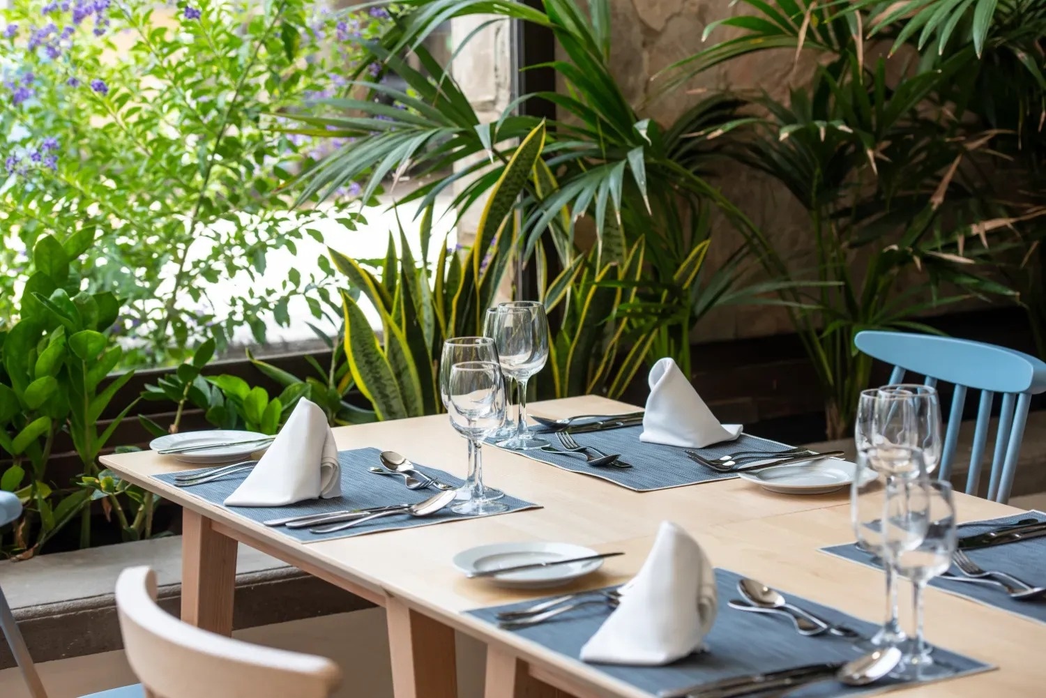 a table set for a meal with a blue chair
