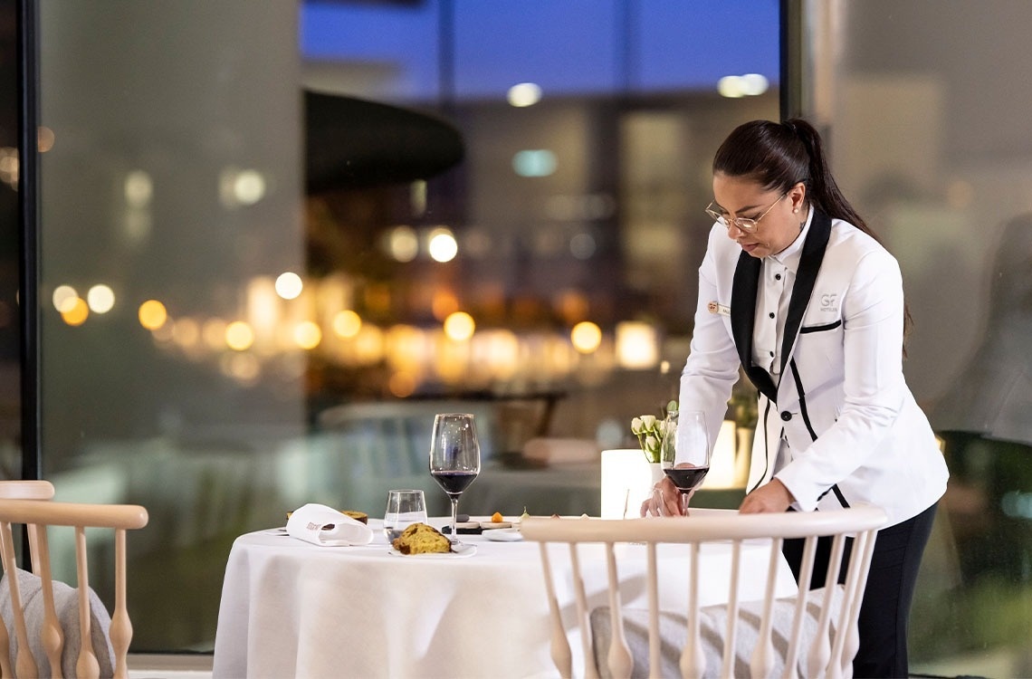 a woman in a white jacket with the letter s on it