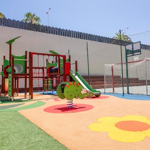 a children 's playground with a flower on the floor