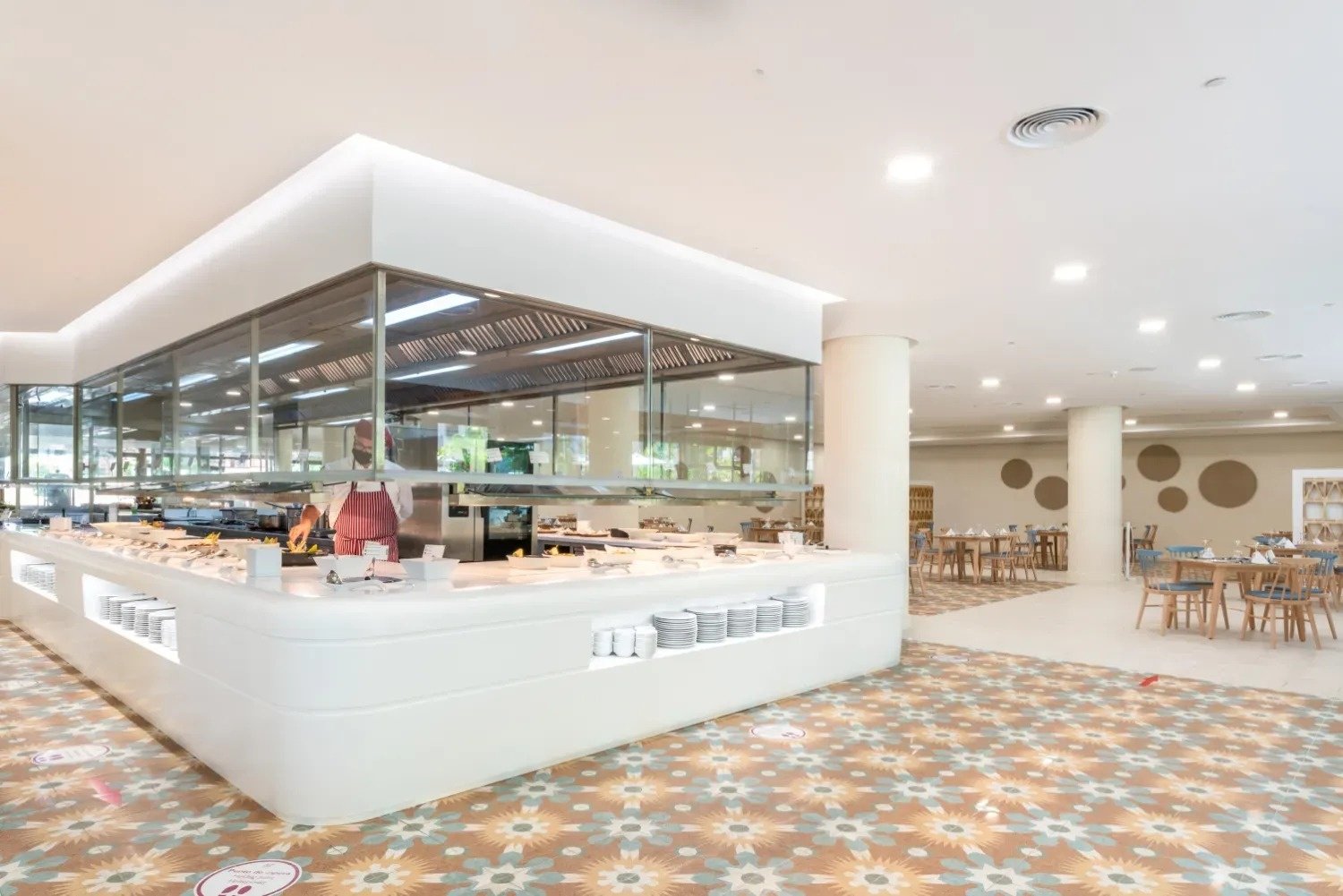 a buffet area in a restaurant with a sign on the floor that says social distancing