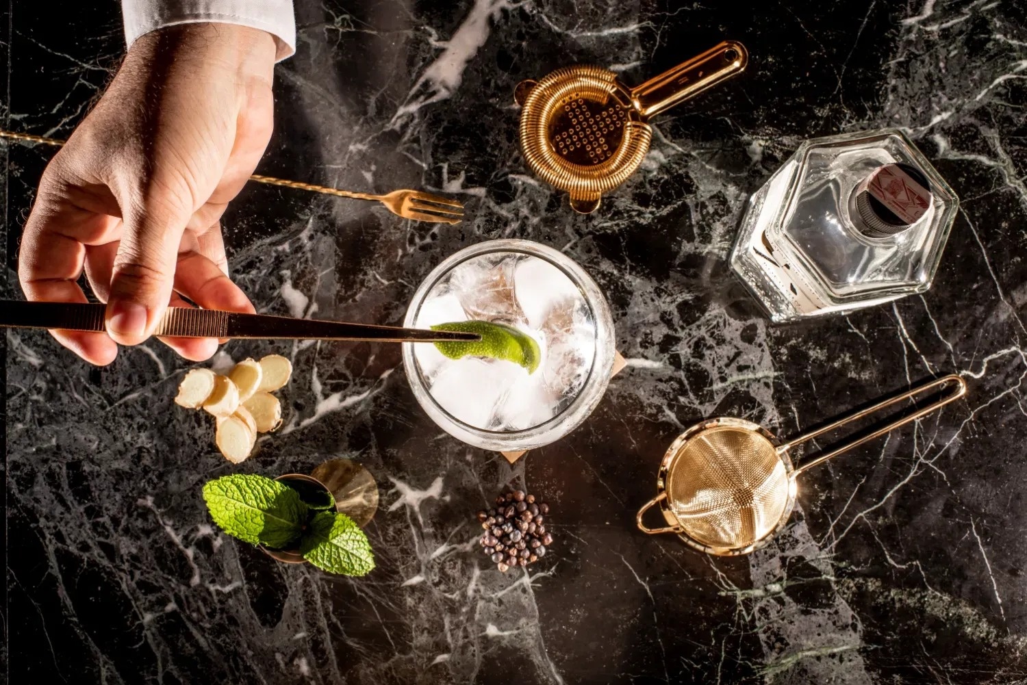 a bartender prepares a drink with a bottle of vodka in the background