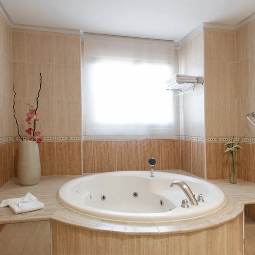 a bathroom with a jacuzzi tub and a window