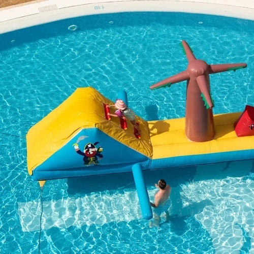 a man is standing in a pool with a pirate inflatable in it