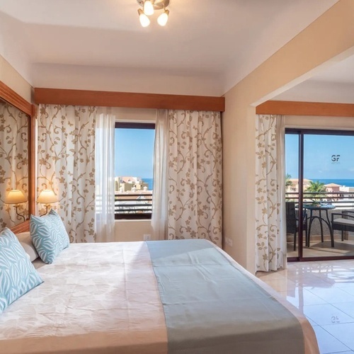 a hotel room with a large bed and a balcony