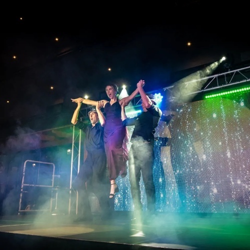 a man and a woman are dancing on a stage