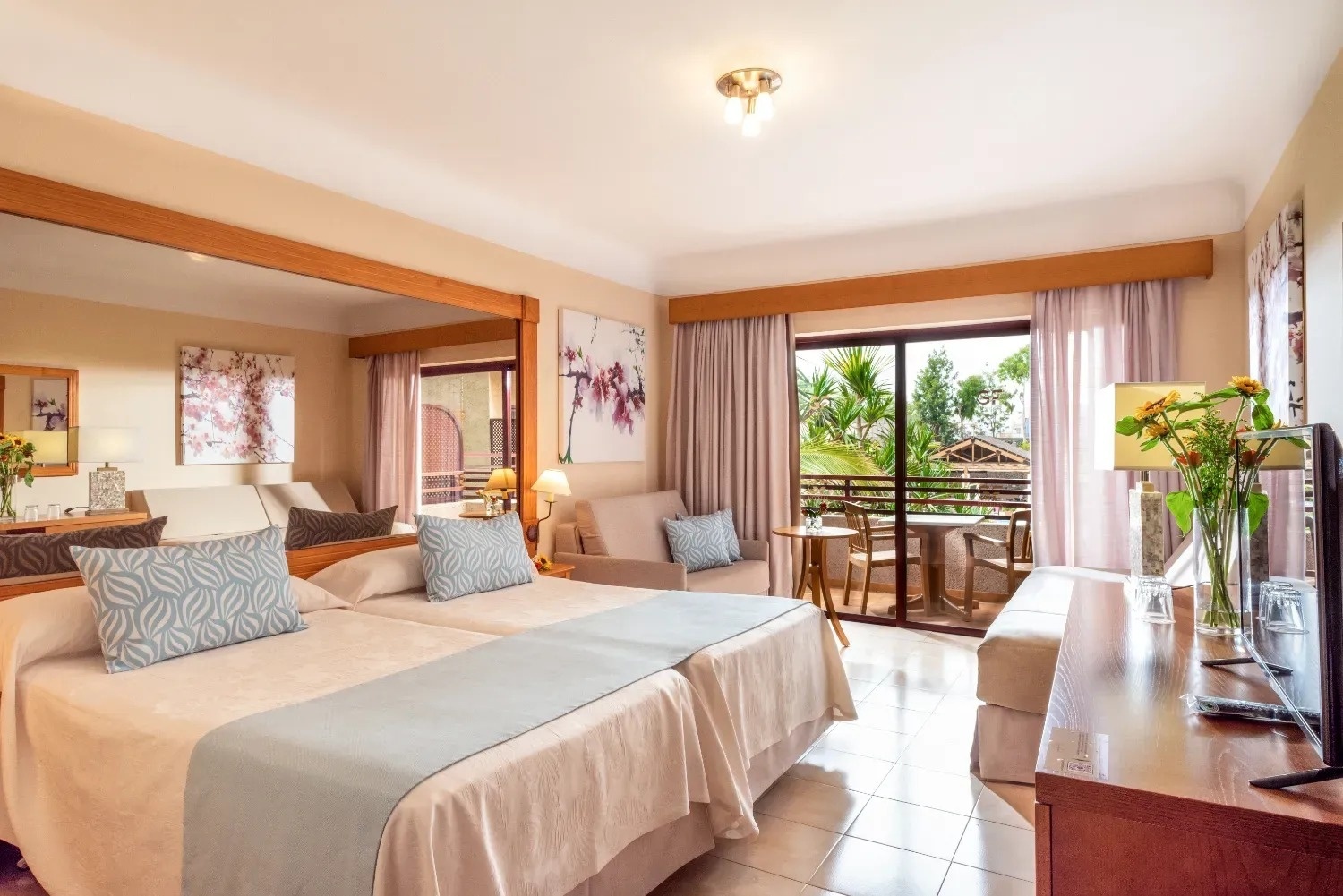 a hotel room with two beds and a sliding glass door