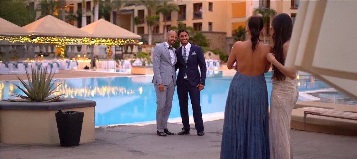 an aerial view of a sandy beach with blue water