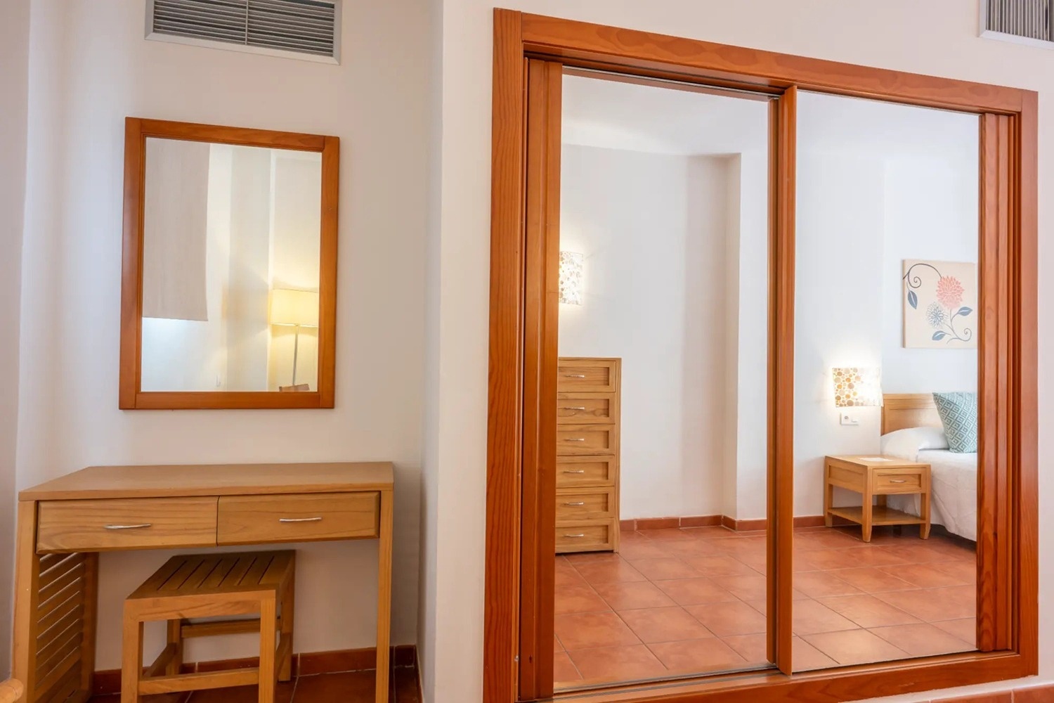 un dormitorio con un espejo y una puerta corrediza