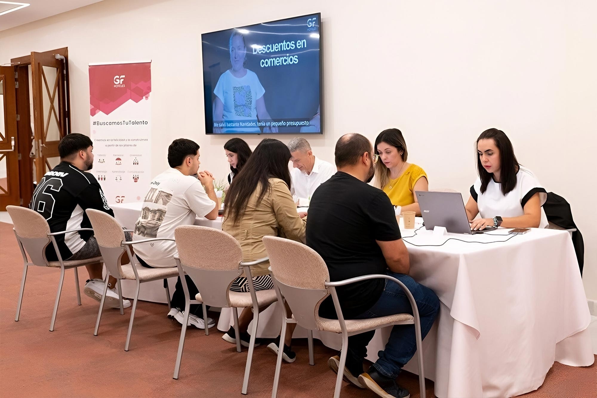 a man stands at a reception desk in a lobby