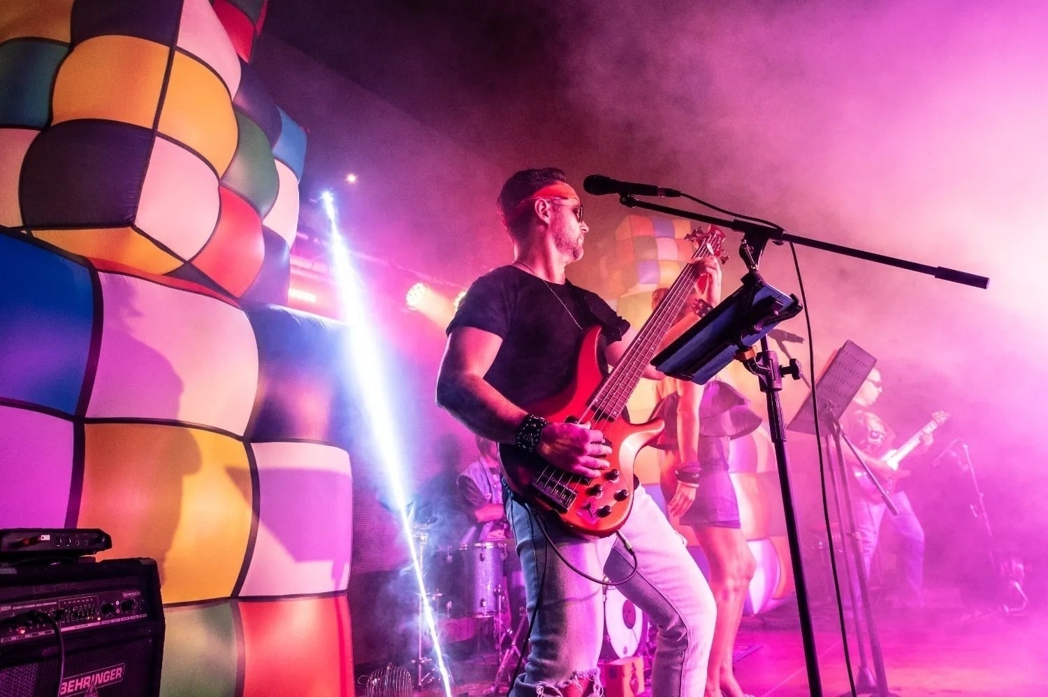 a man stands on a rocky beach near the ocean