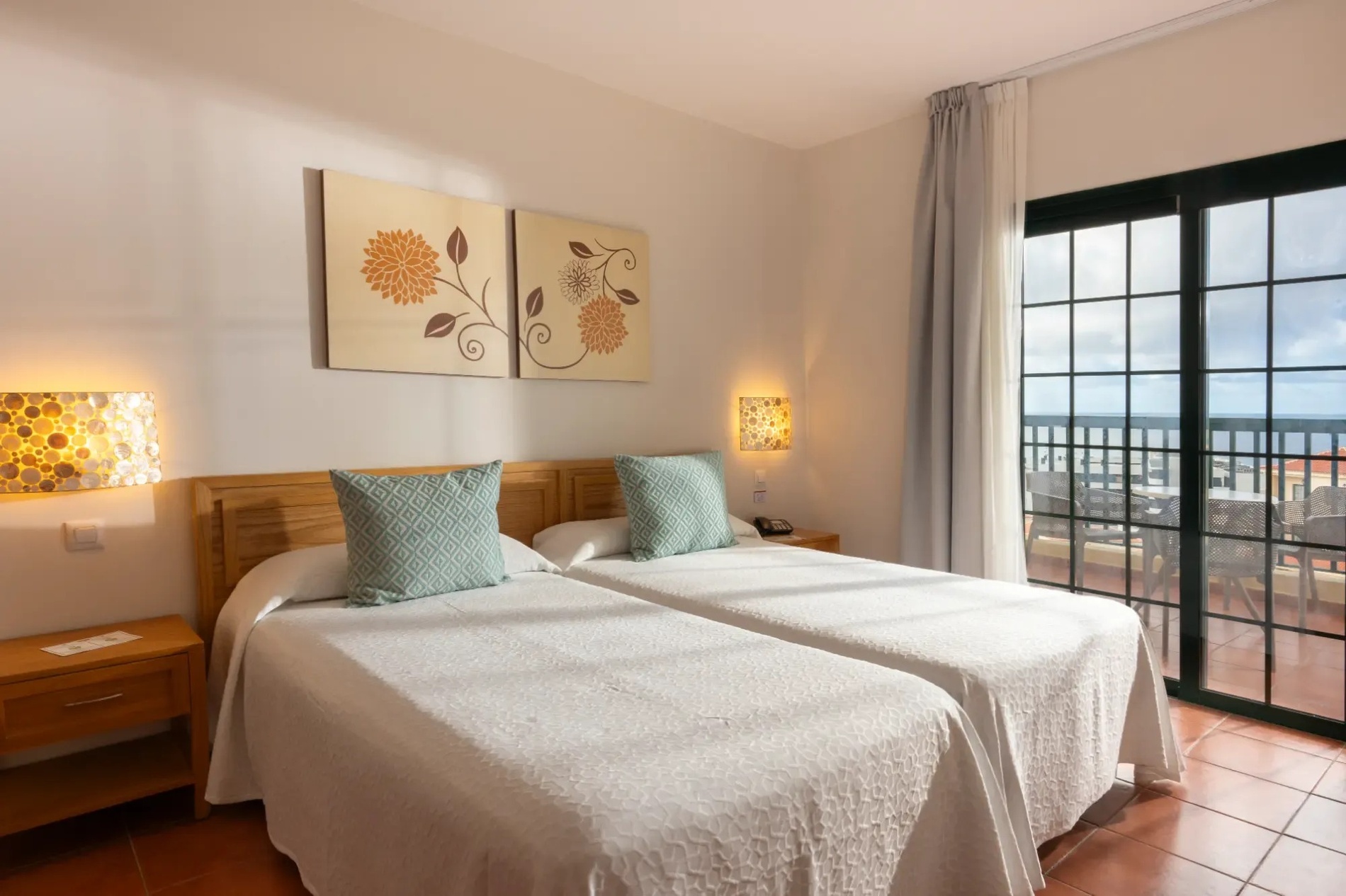 a bedroom with two beds and a sliding glass door