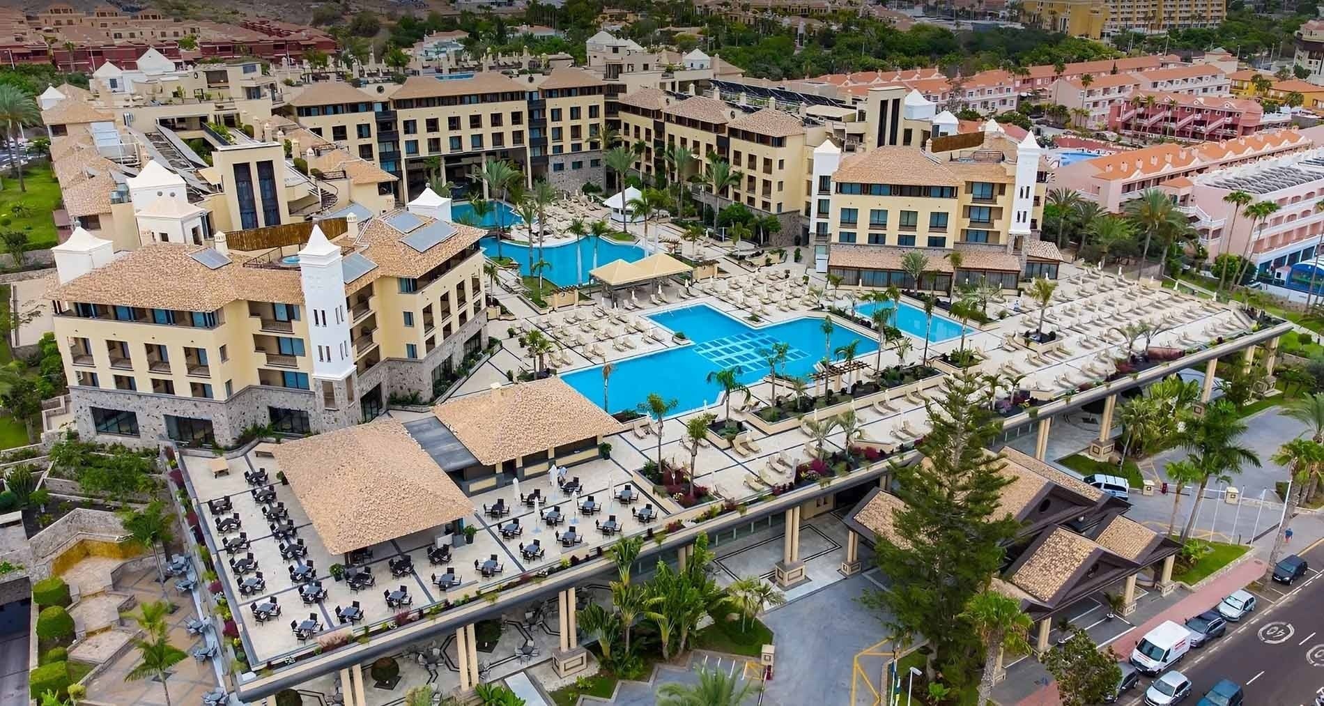 a swimming pool with umbrellas and chairs around it