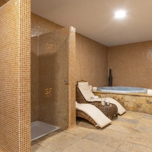 a bathroom with a walk in shower and a hot tub