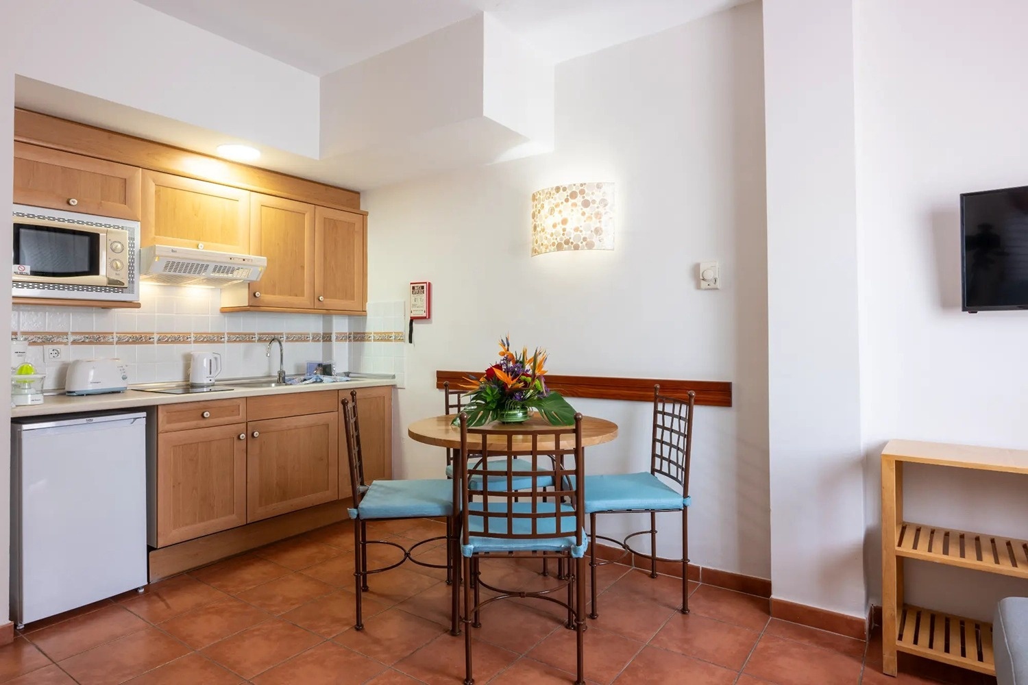 una cocina con una mesa y sillas y un microondas