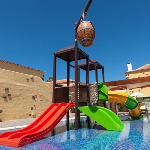 a pool with a slide and a barrel hanging from it