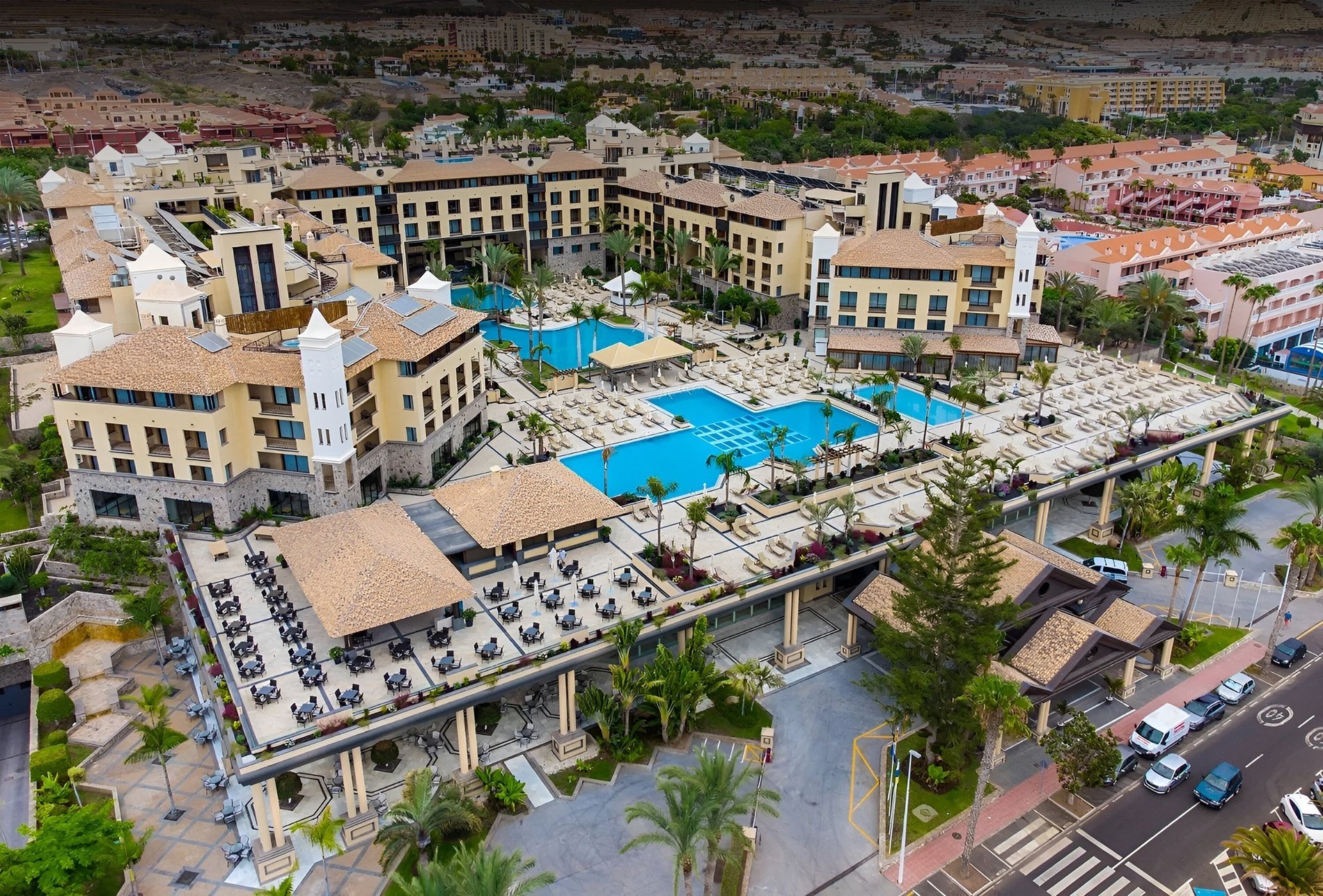 a swimming pool with umbrellas and chairs around it