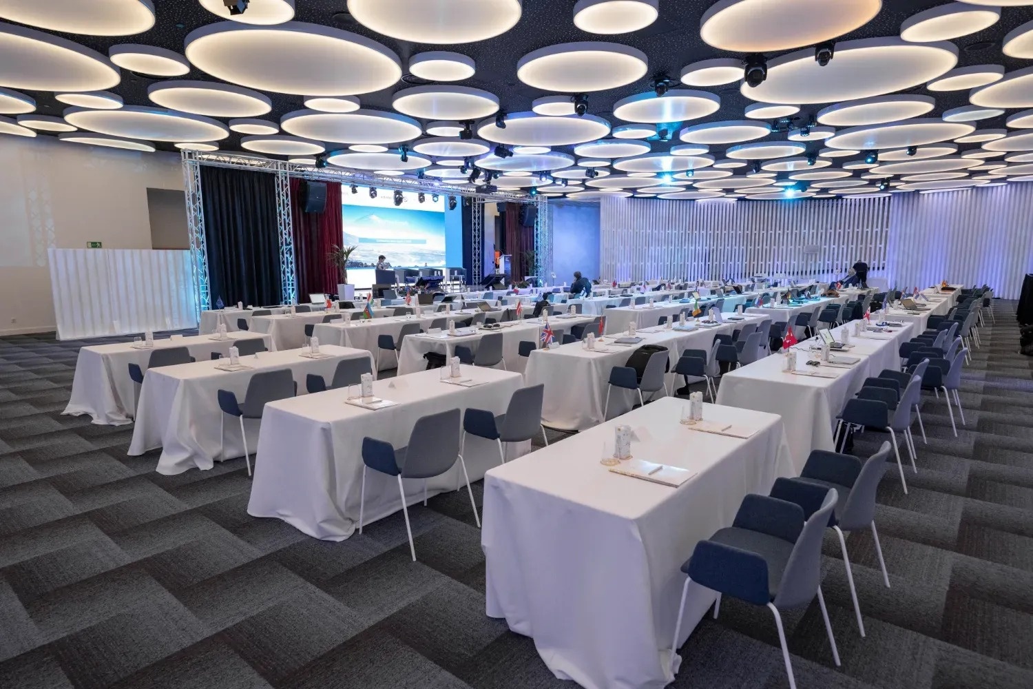 a large room with tables and chairs set up for a conference