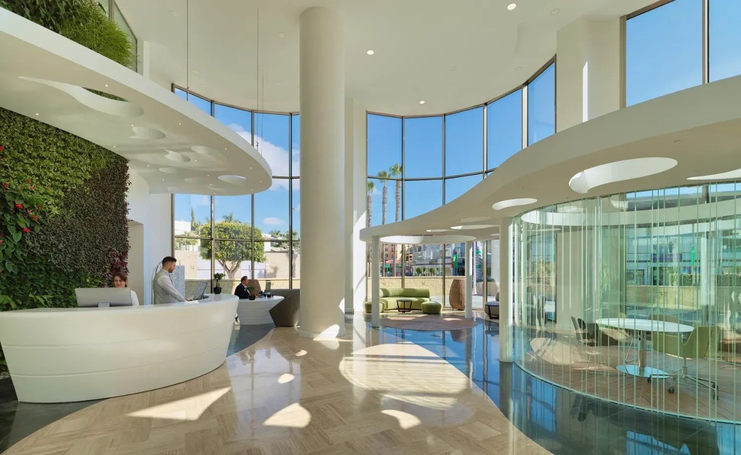 a man stands at a reception desk in a lobby