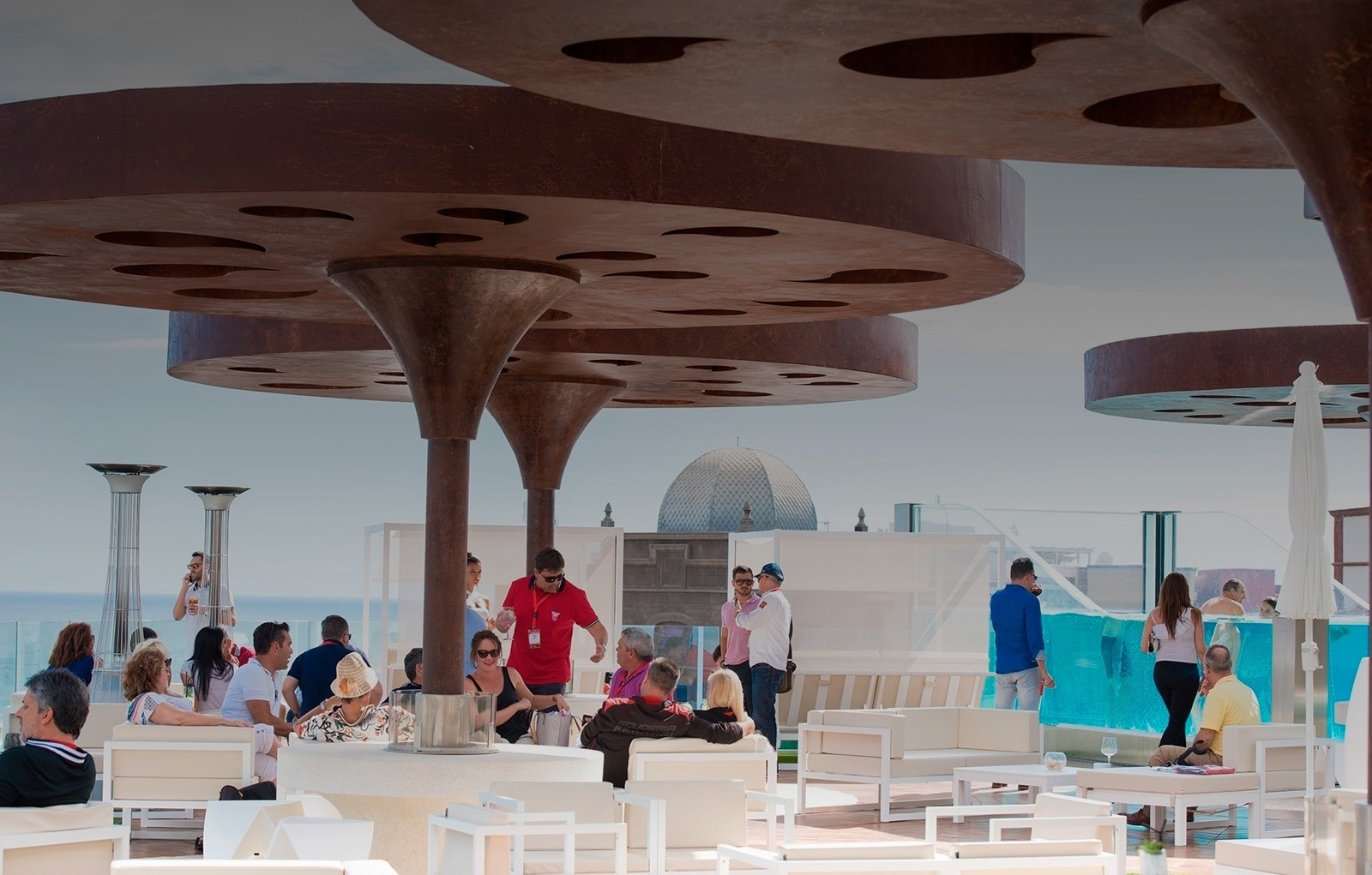 a man in a red shirt stands in front of a group of people