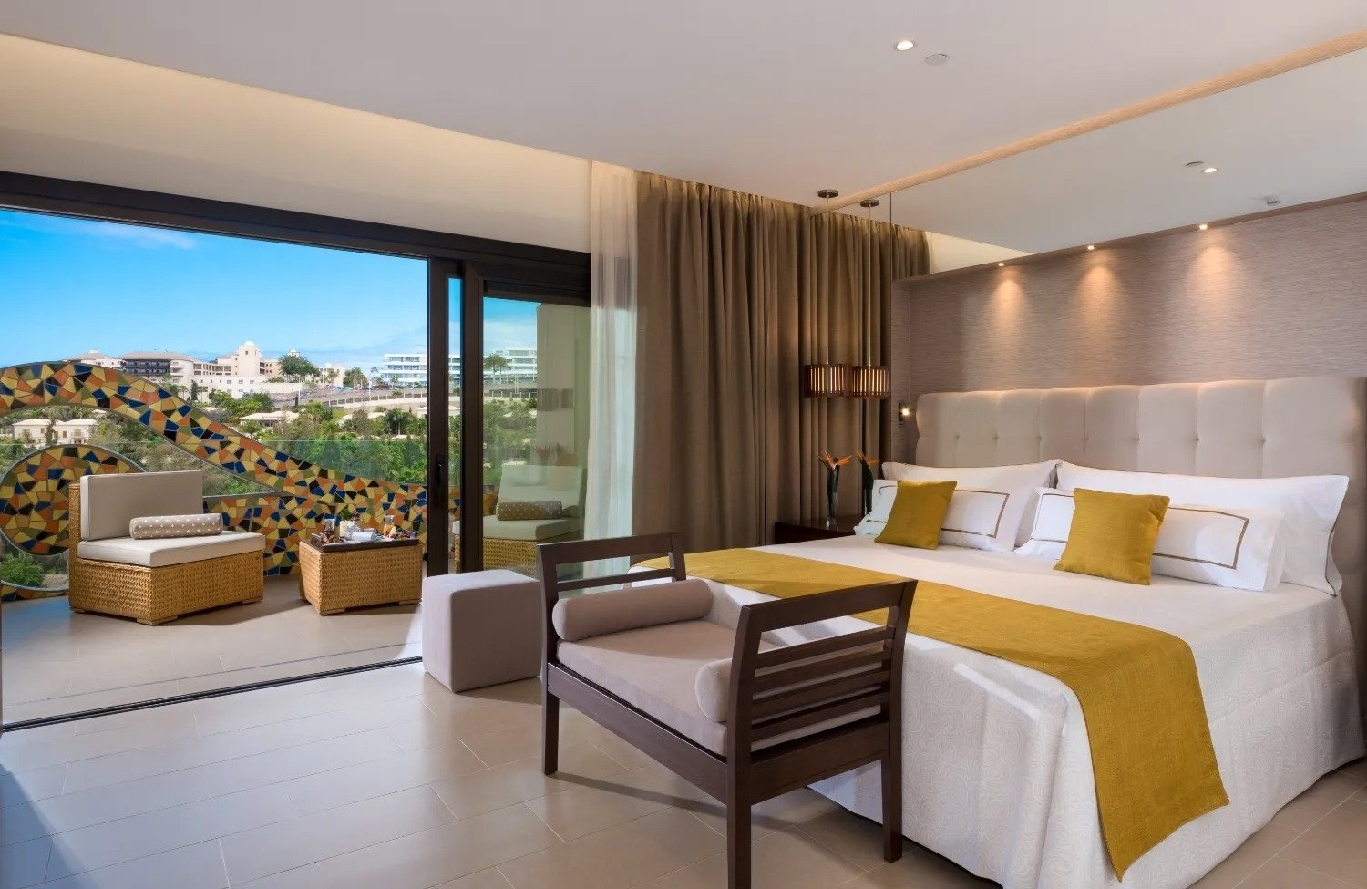 a hotel room with a large bed and a sliding glass door