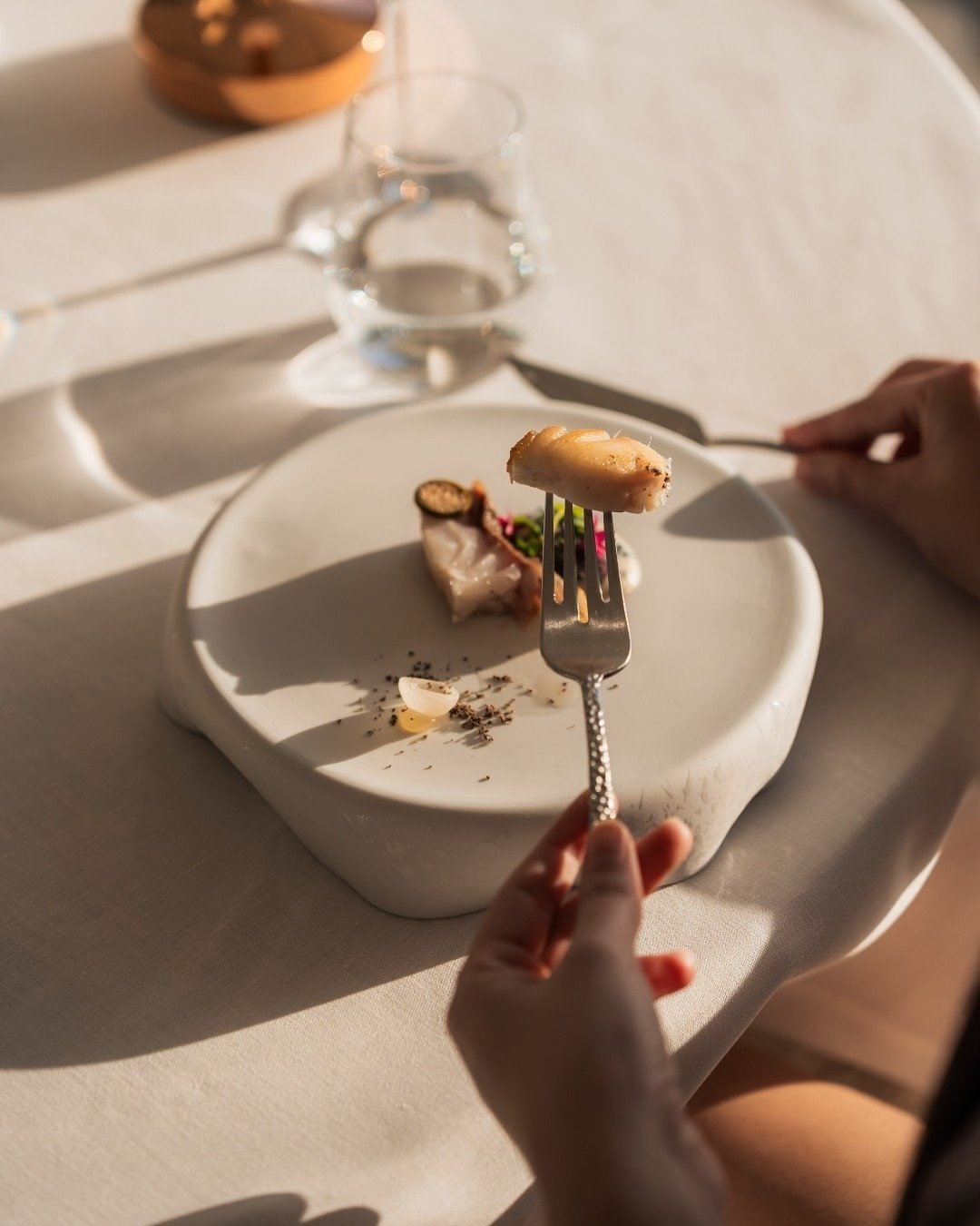 an aerial view of a sandy beach with blue water