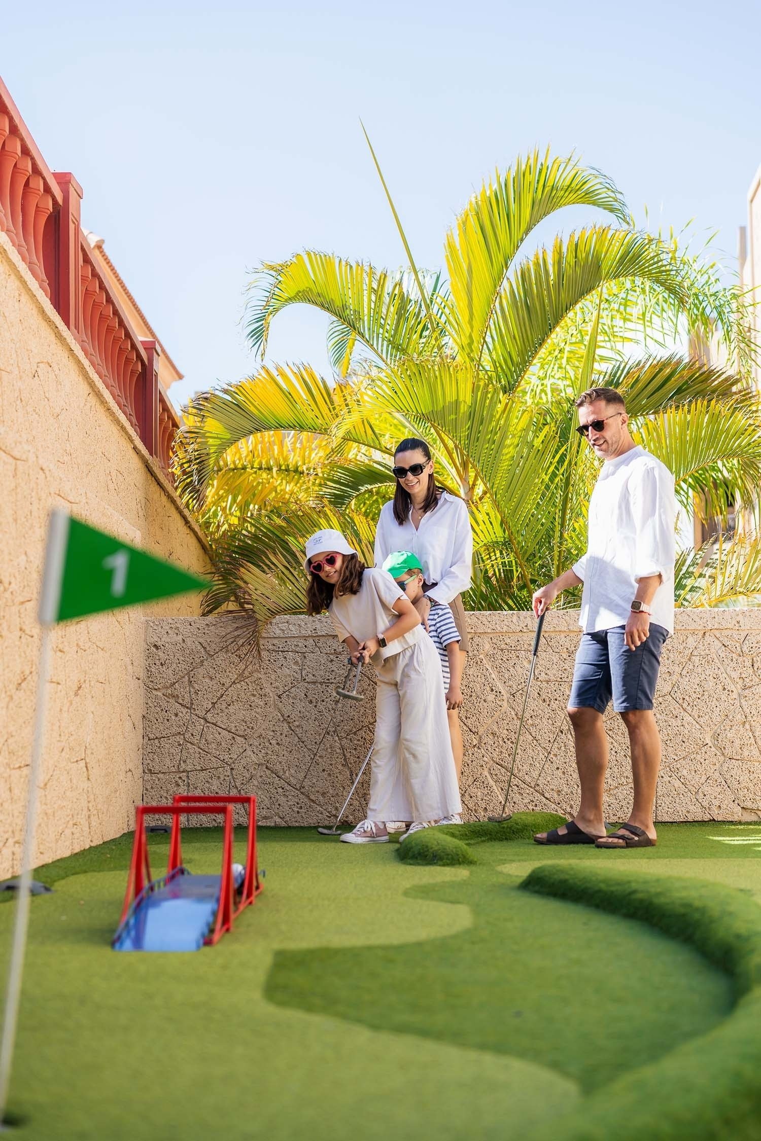 a group of people are playing a game of mini golf