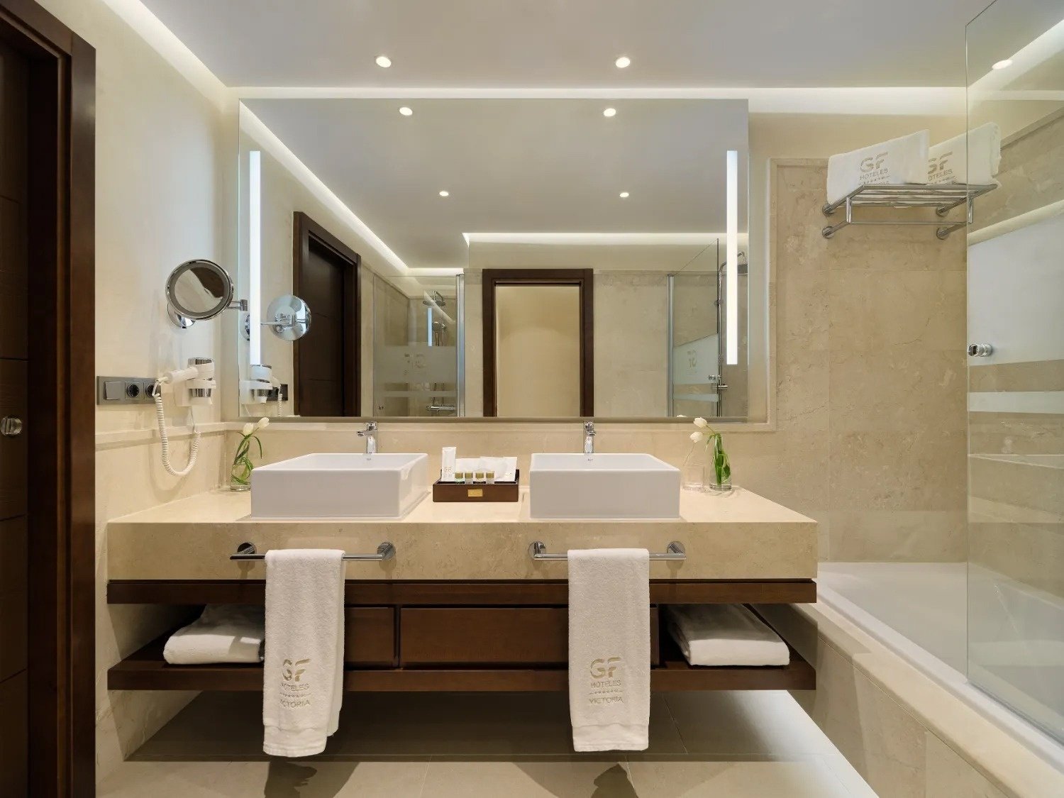 a bathroom with two sinks and two towels that say sf