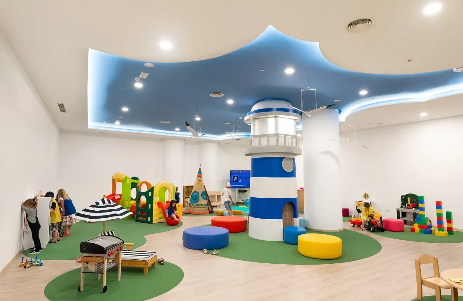 a children 's play area with a lighthouse in the middle