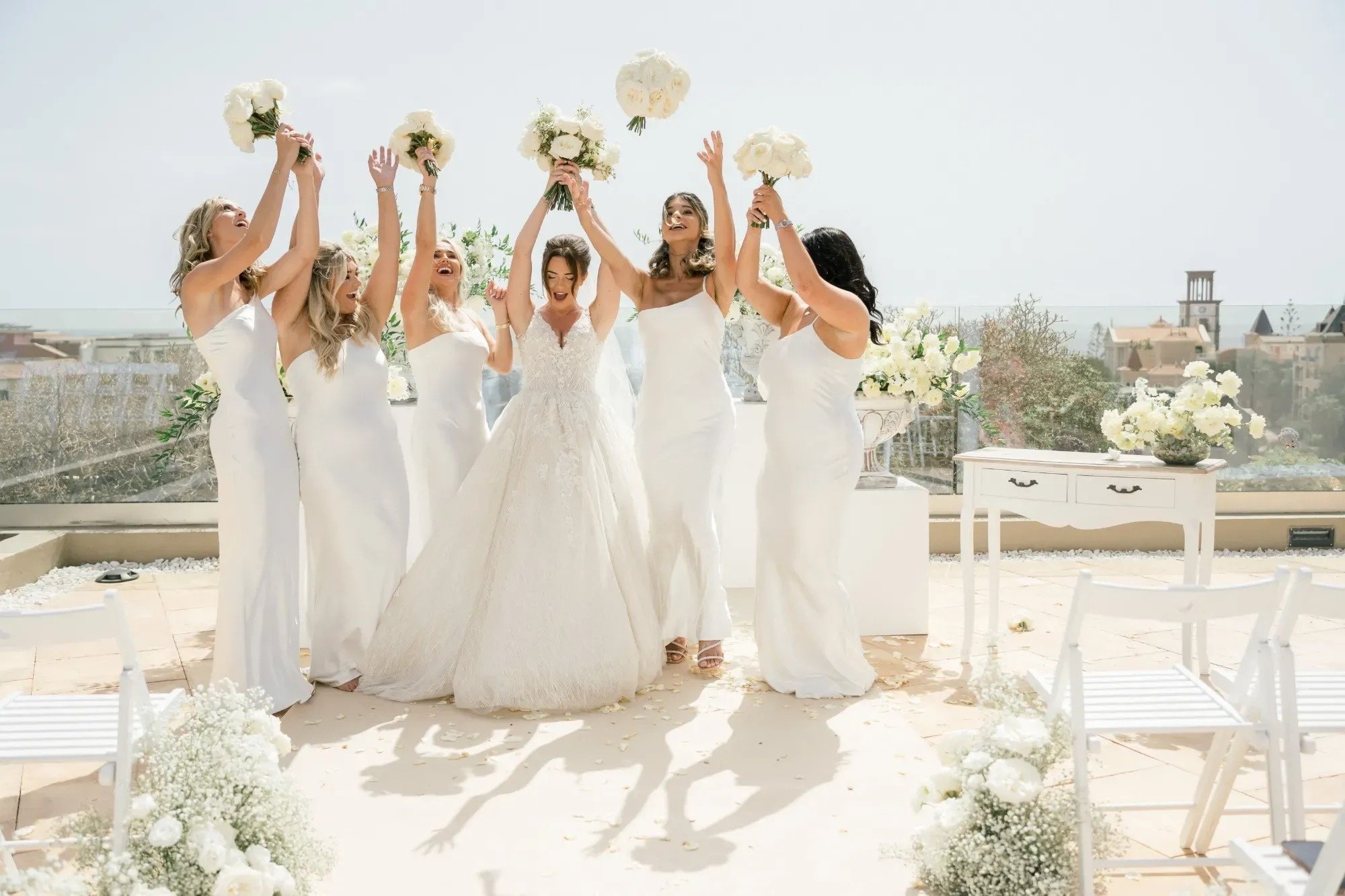 the bride and her bridesmaids are throwing their bouquets in the air