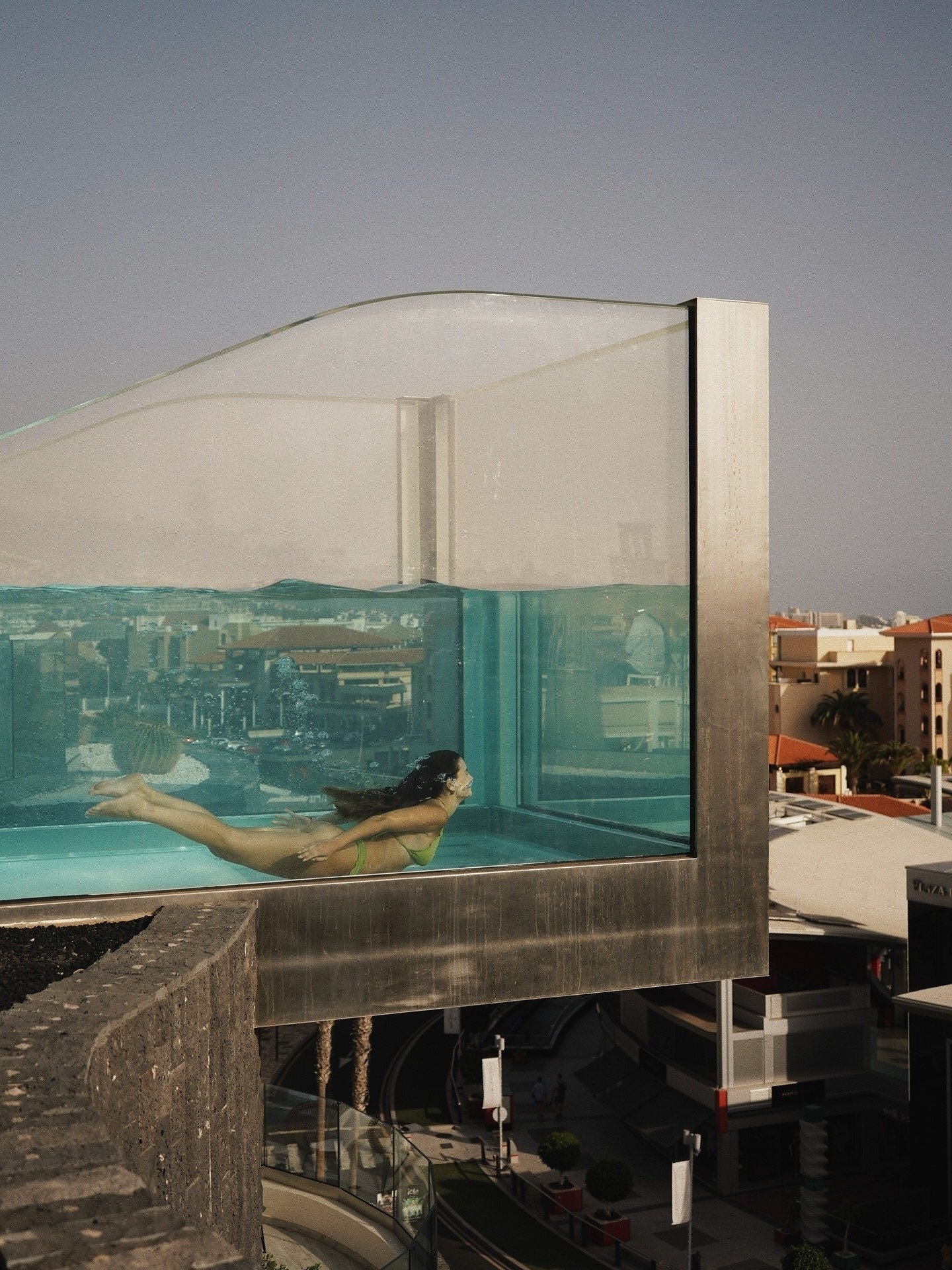an aerial view of a sandy beach with blue water