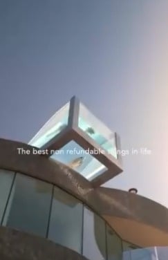 an aerial view of a sandy beach with blue water
