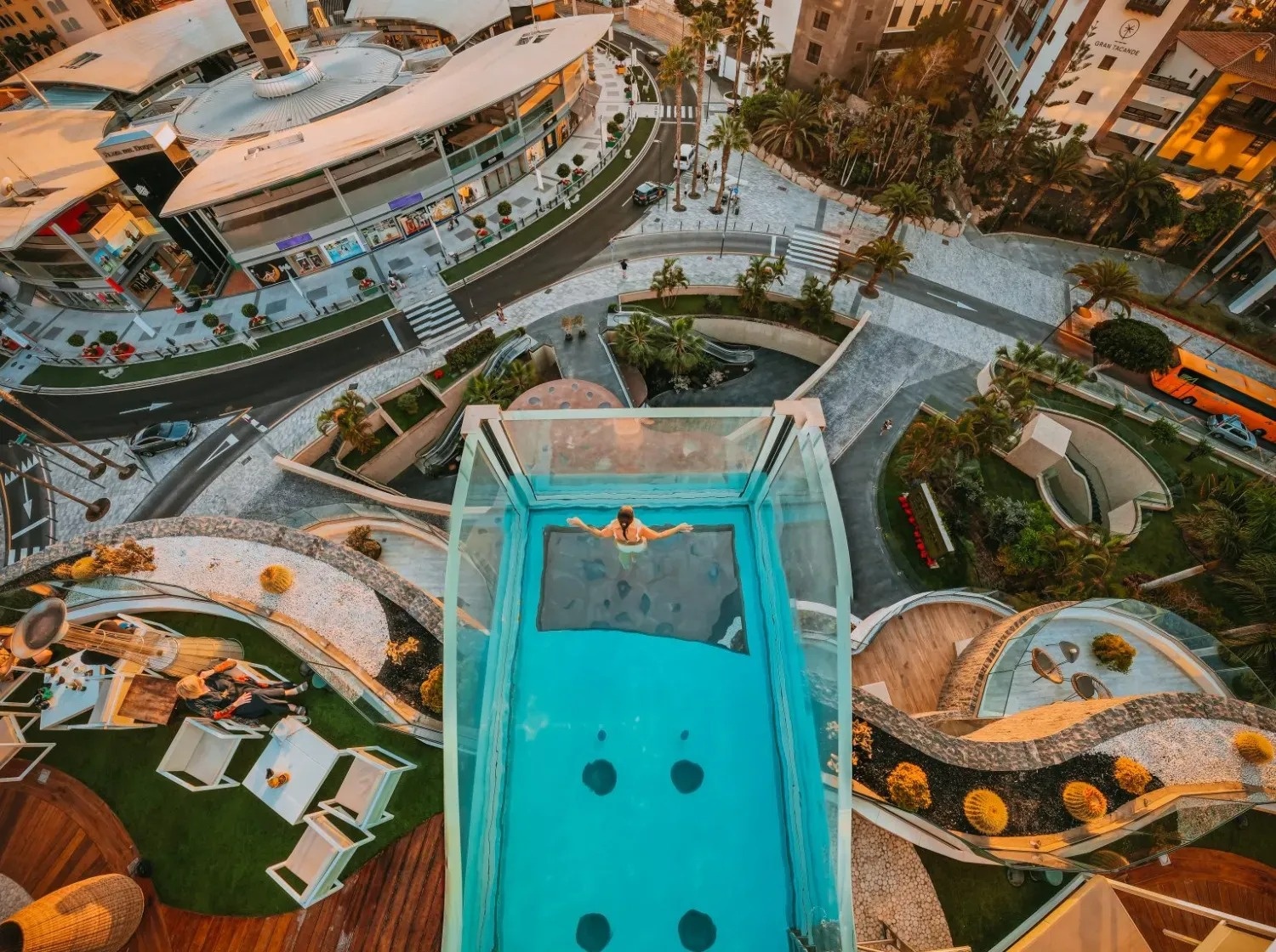 an aerial view of a city with a swimming pool in the middle