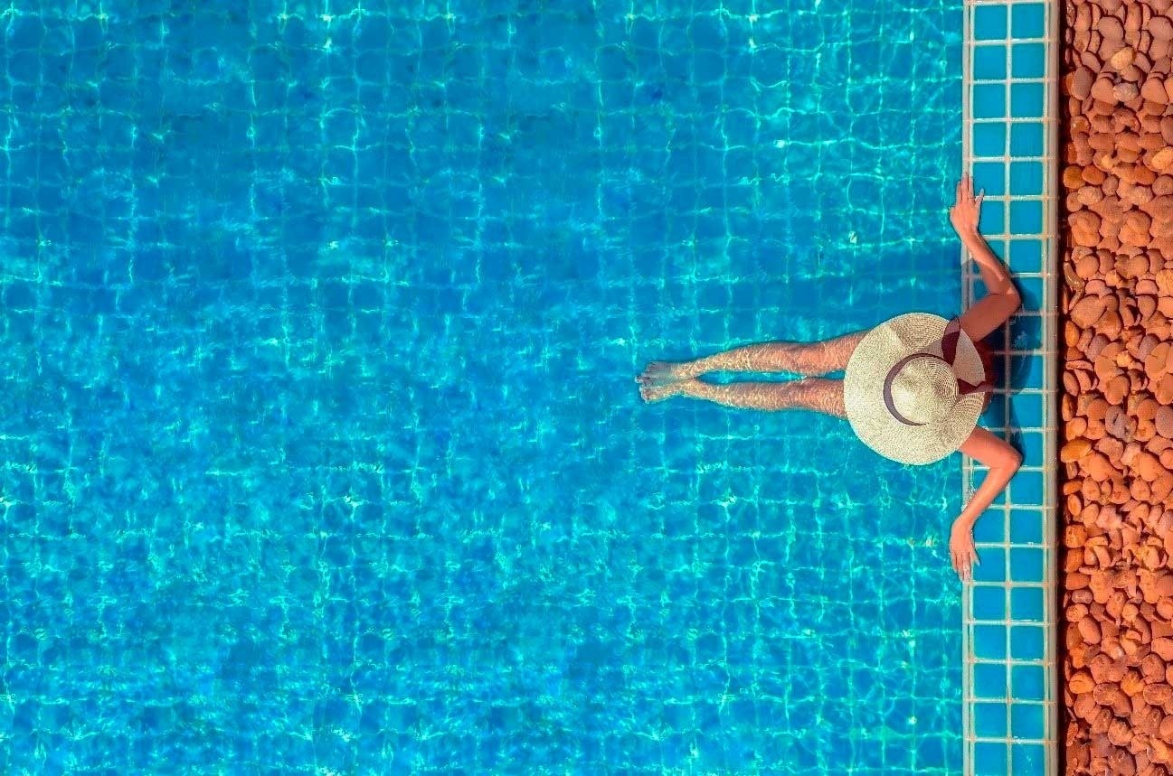 a beach at sunset with buildings in the background