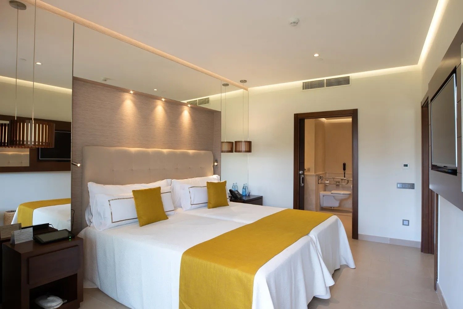 a hotel room with two beds and a bathroom