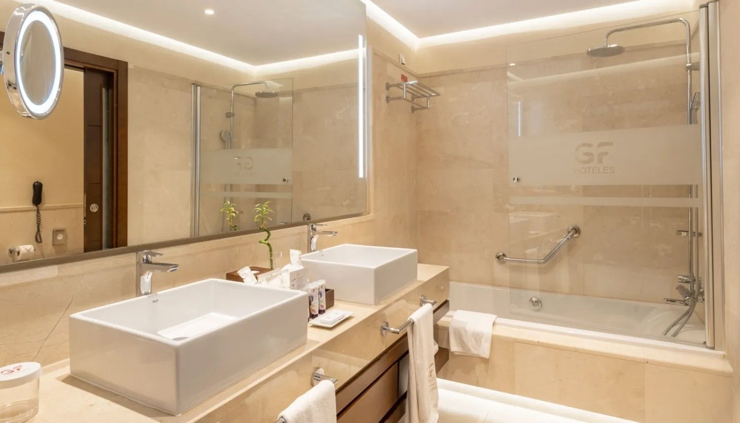 a hotel bathroom with two sinks and a bathtub